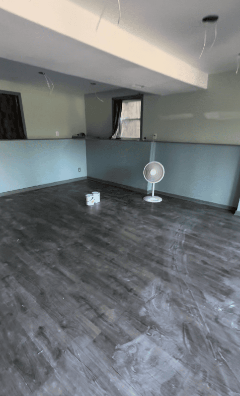 Basement before finishing showing exposed concrete and framing